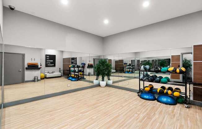 A bowling alley with wooden floors and bowling balls on racks. at Northpoint Apartments, Tacoma