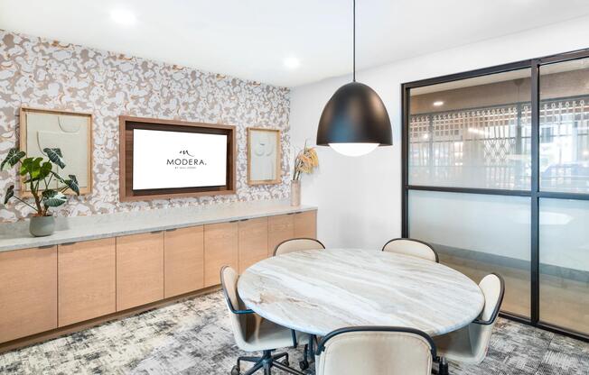 Polished conference room at Modera Higley Commons, offering a refined setting with thoughtful design for collaboration and connection.