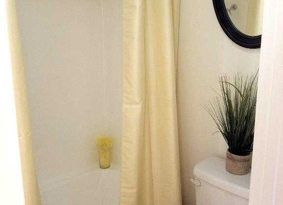 Large Soaking Tub In Master Bathroom With A Tile Surround at Citrus Gardens Apartments, Fontana, CA, 92335