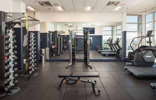 a gym with weights and cardio equipment in a building