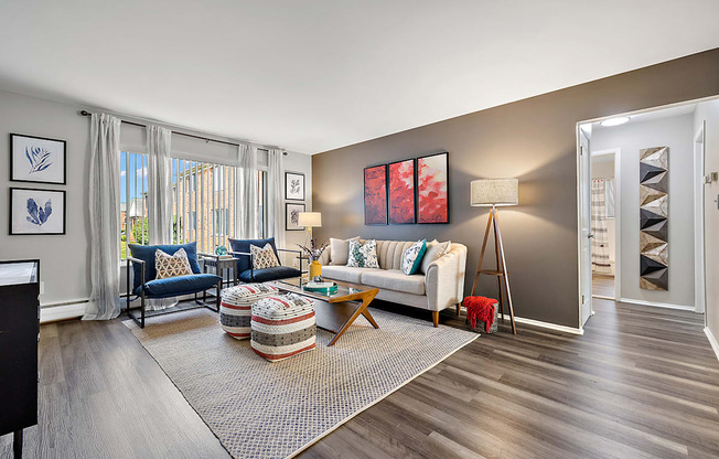 spacious living room with wood flooring and windows at the reserve apartments