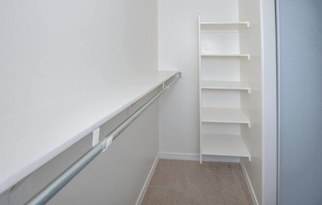 A white staircase with a metal handrail.
