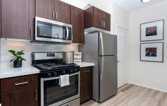 a kitchen with stainless steel appliances and wooden cabinets