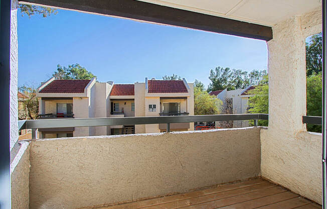 a balcony with a view of houses and trees