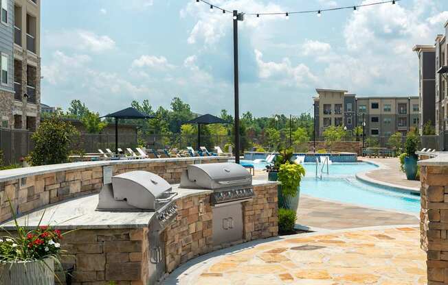 A pool area with a hot tub and a wall of buildings in the background.