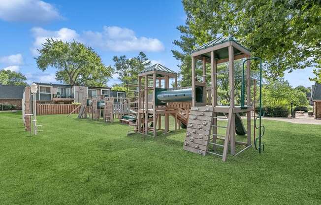 a playground with a lot of play equipment in a yard