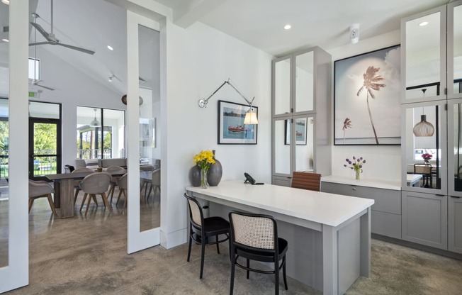 Office in resident clubhouse with a large white desk and two black chairs at Odyssey, Florida