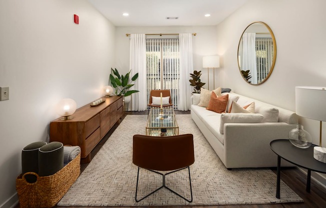 a living room with white furniture and a glass table