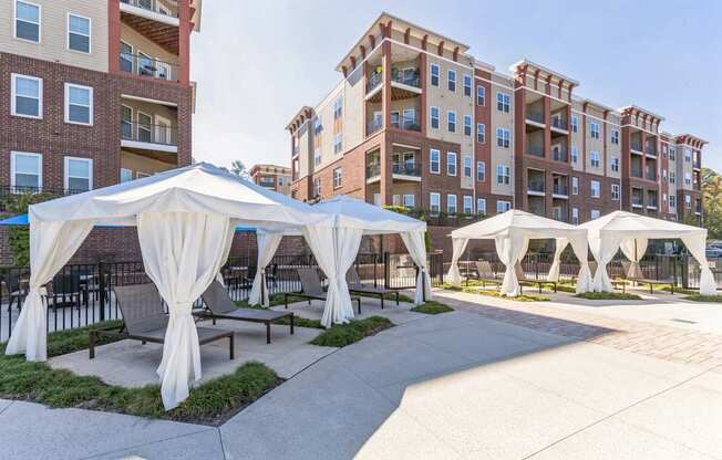 A large white tent is set up in front of a building.