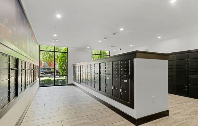 a large room with a wall of mailboxes and a large window