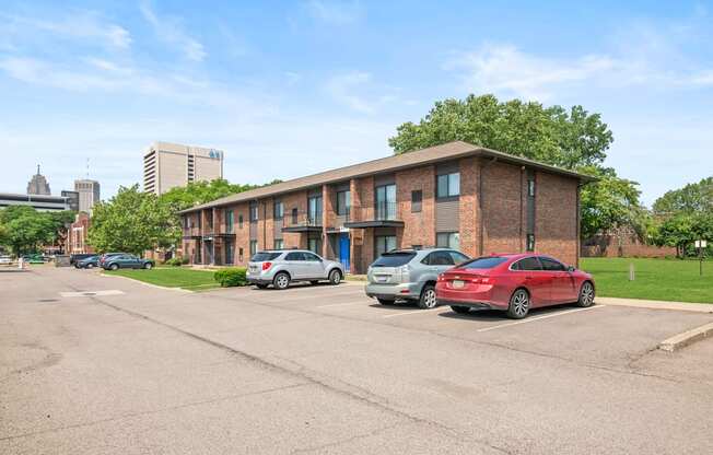 a brick apartment building with a parking lot in front of it at Lafayette Park Place, Detroit, MI, 48207