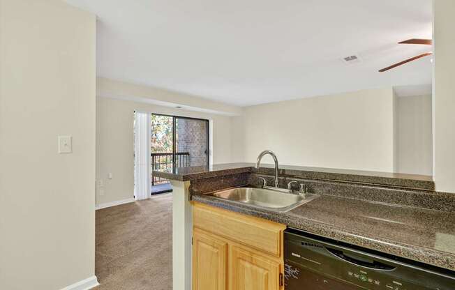 A kitchen with a sink and a dishwasher.