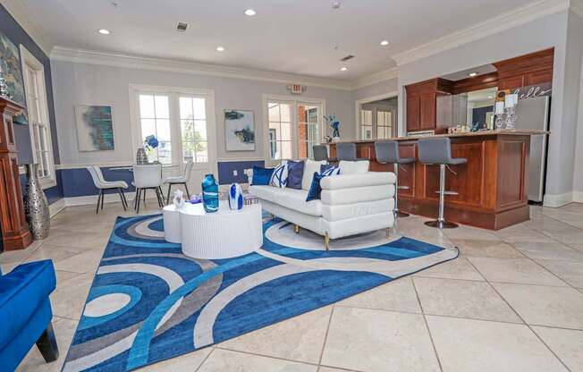 Resident lounge with couch and kitchen at Ultris Island Park in Shreveport, LA