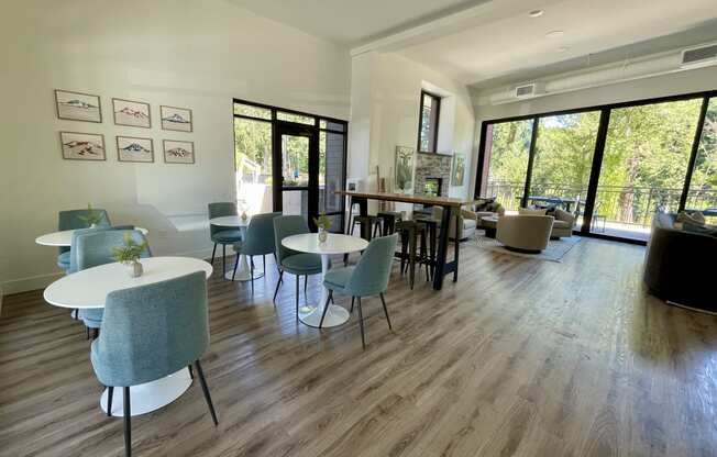 a room with hardwood floors and large windows at Commons on the Tualatin River, Tualatin