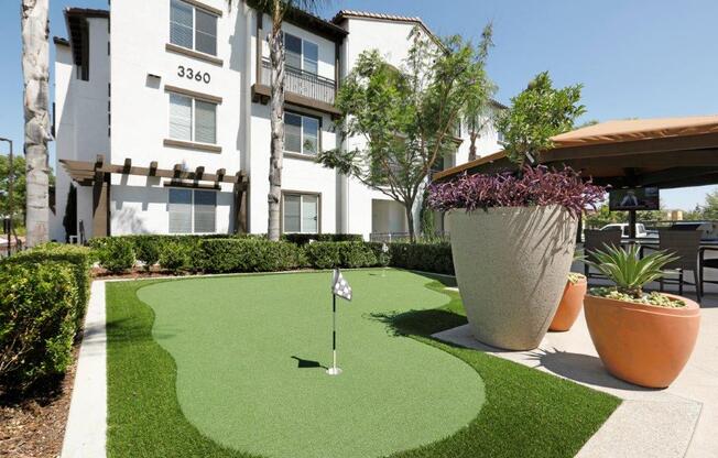 a putting green in front of an apartment building