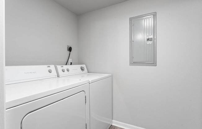 A white washing machine and dryer in a small laundry room.