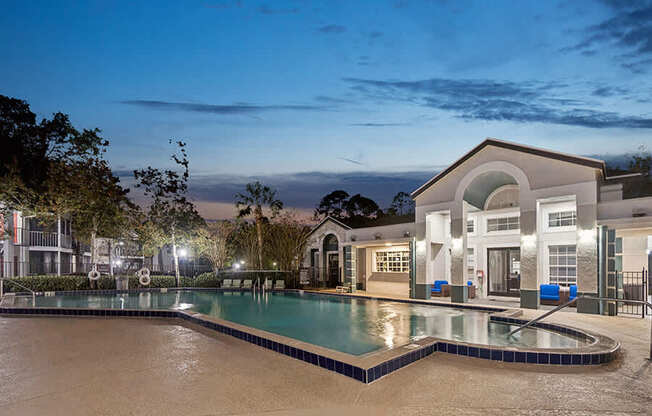 Community Swimming Pool with Pool Furniture at Vue at Baymeadows Apartments in Jacksonville, FL.