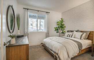 a bedroom with a bed and a dresser and a window