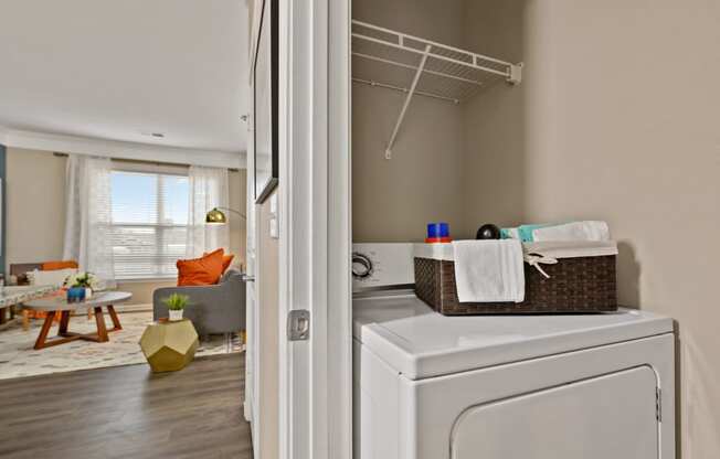 Riverstone Apartments In-Unit Laundry Room with Full-Size Washer/Dryer and Shelving