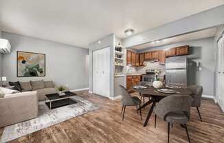 a living room and dining room with a table and chairs