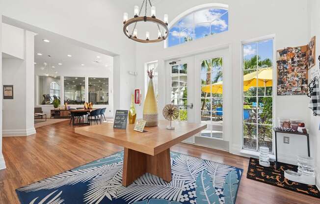 A large room with a wooden table and a chandelier.
