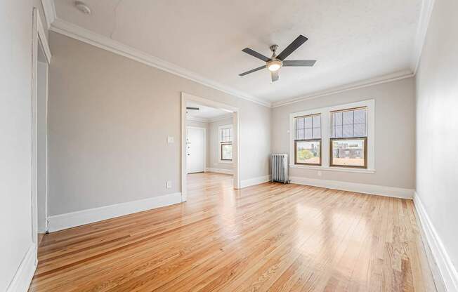 Dining room with hardwood floors and a ceiling fan.