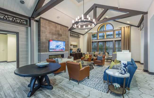 a living room with couches and chairs and a television