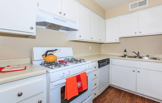 a kitchen with a stove a sink and a microwave