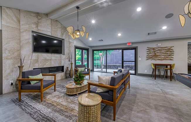 A living room with a flat screen TV mounted on a stone wall.