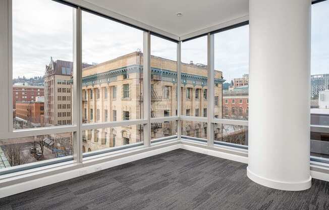 A large room with a view of a cityscape through the windows.