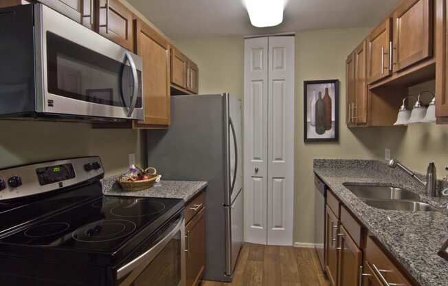 Renovated kitchen with granite counters, vinyl flooring and new cabinets