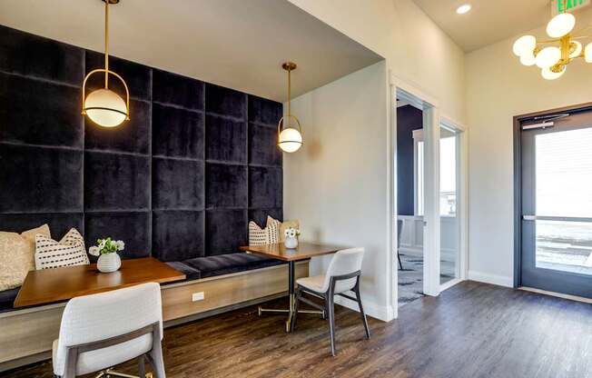 A modern dining area with a wooden table and chairs.