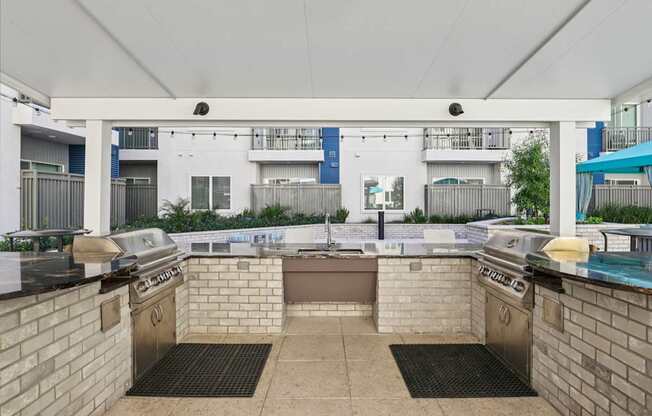 A patio with a grill and a table with a grill on it.