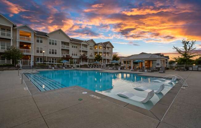 a pool with a reflection of a building and a cloudy sky