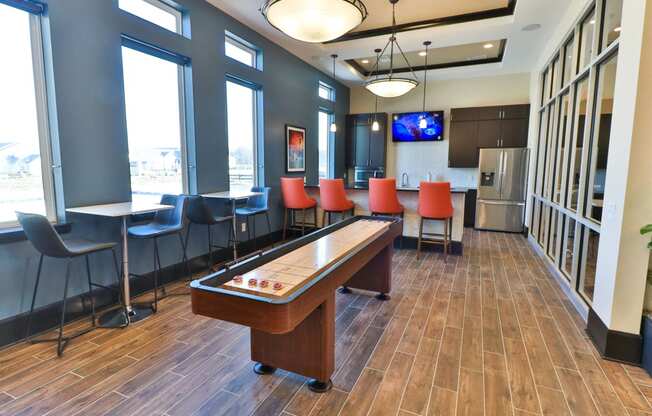 a game room with a pool table and chairs