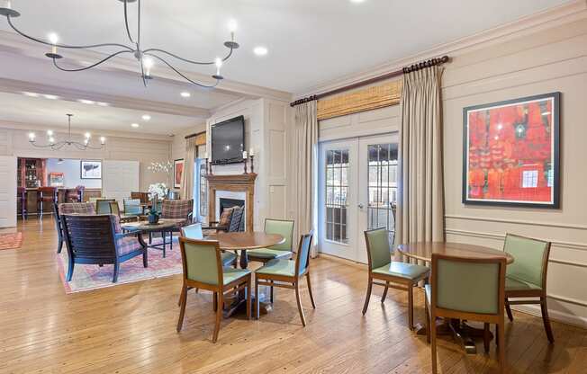 a living room with tables and chairs and a fireplace