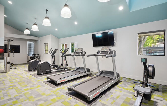 Community Fitness Center with Equipment and Treadmills at Creek 2645 Apartments in Sacramento, CA.