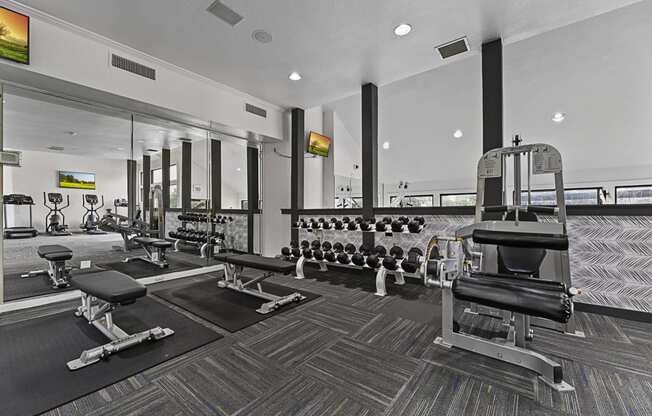 a gym with weights and cardio equipment at the estates at johnston crossing apartments at Lakeside Apartments, Dallas, TX, 75231