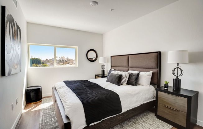 a bedroom with a large bed and a window
