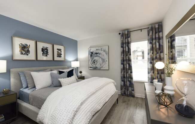 a bedroom with blue and white walls and a bed with pillows