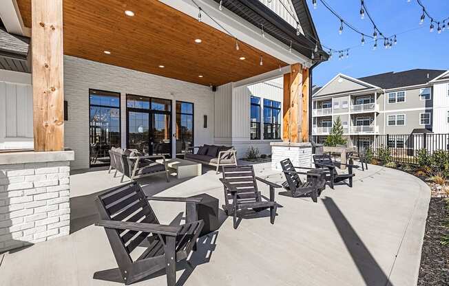 A patio with chairs and a fireplace.