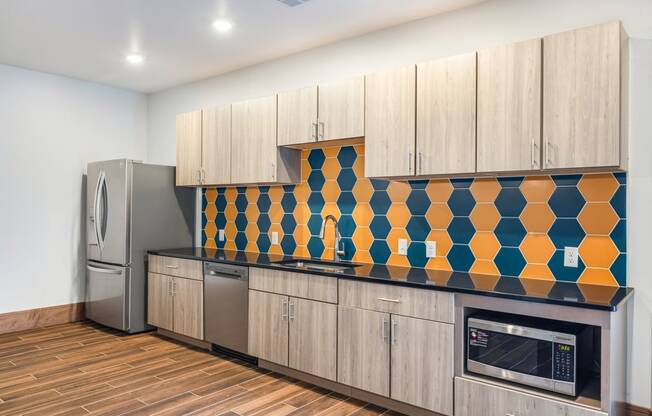 a kitchen with wooden cabinets and a stainless steel refrigerator