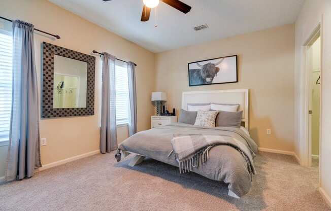 a bedroom with a bed and a ceiling fan