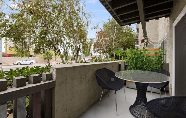 a patio with a table and chairs on a balcony