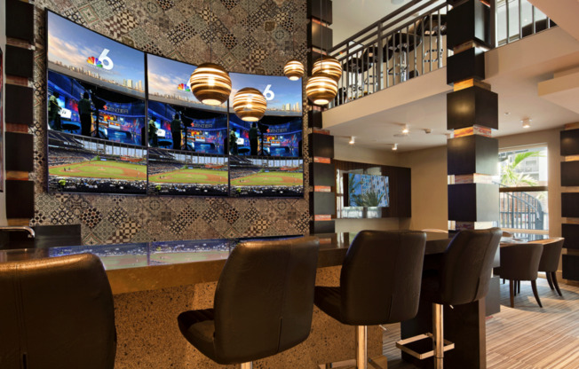 Hip sports lounge with flat screen TVs and bar-style seating