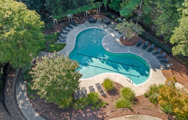 an aerial view of a swimming pool with trees and a courtyard at View at Lake Lynn, Raleigh, 27613