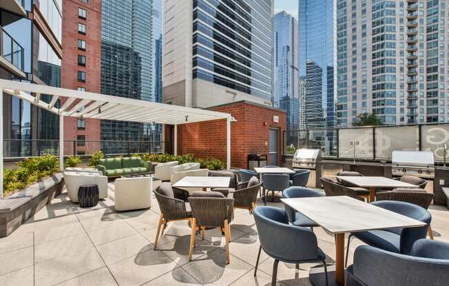 a rooftop patio with tables and chairs and skyscrapers in the background at Cassidy on Canal, Chicago