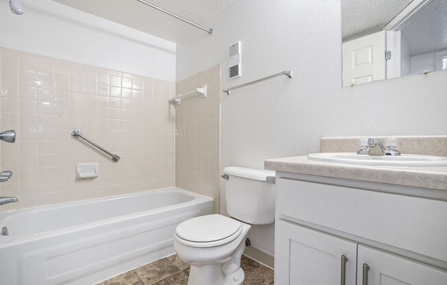 a bathroom with a sink toilet and a bath tub at Apple Ridge Apartments, Michigan, 49534