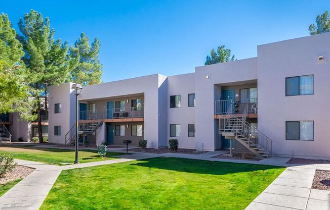A modern building with a green lawn in front.