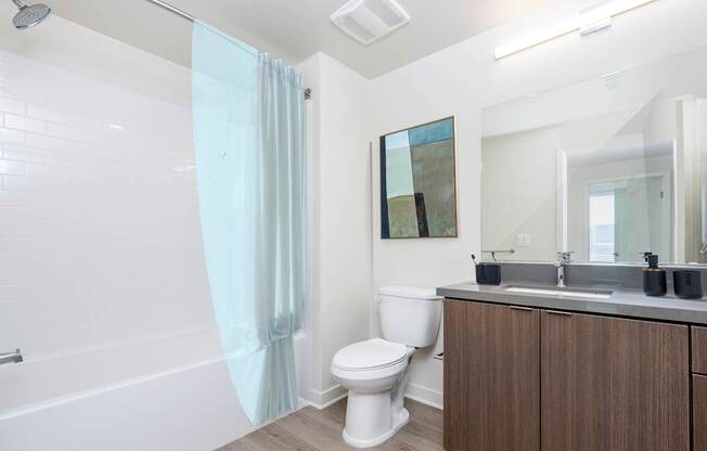 A white toilet sits next to a sink in a bathroom.